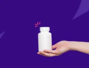 A hand holding a white Rx pill bottle: The best painkillers for tooth nerve pain