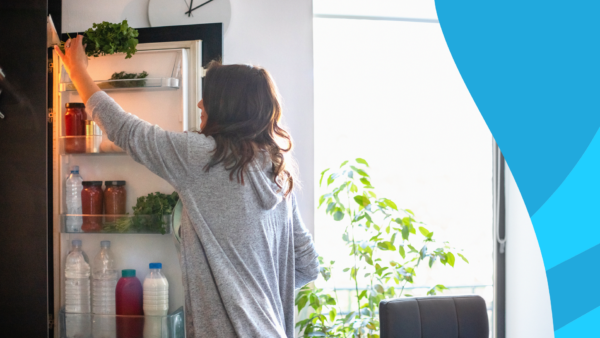 A woman reaching into the refrigerator | How long can Emgality be out of the fridge?