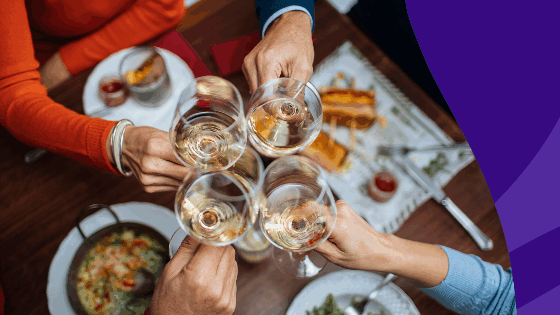 Group of people clinking glasses at dinner - leflunomide and alcohol