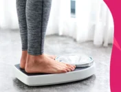 Woman standing on a scale - Does estradiol cause weight gain?