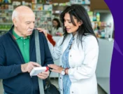 Image of a pharmacist with an older adult - carvedilol side effects in elderly