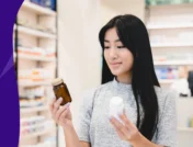 Woman holding a bottle of medication - gabapentin and Tylenol