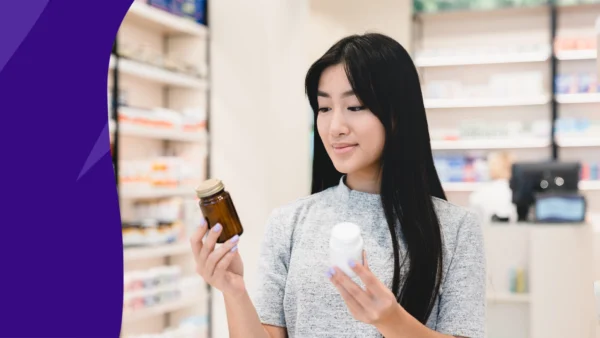 Woman holding a bottle of medication - gabapentin and Tylenol