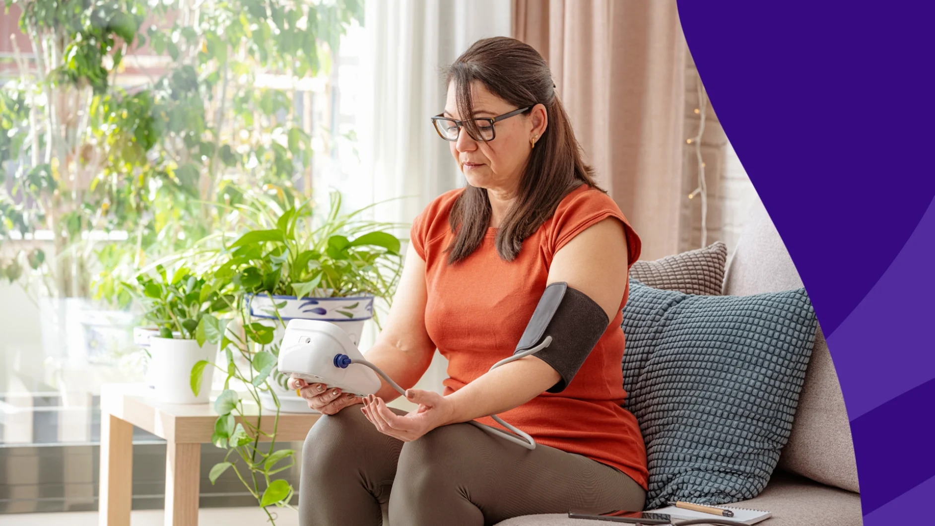 Woman seated at a window looking at a medication bottle - Does Adderall raise blood pressure?