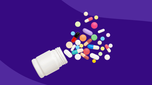 A white pill bottle with various types of pills spilling out: Wegovy pill form