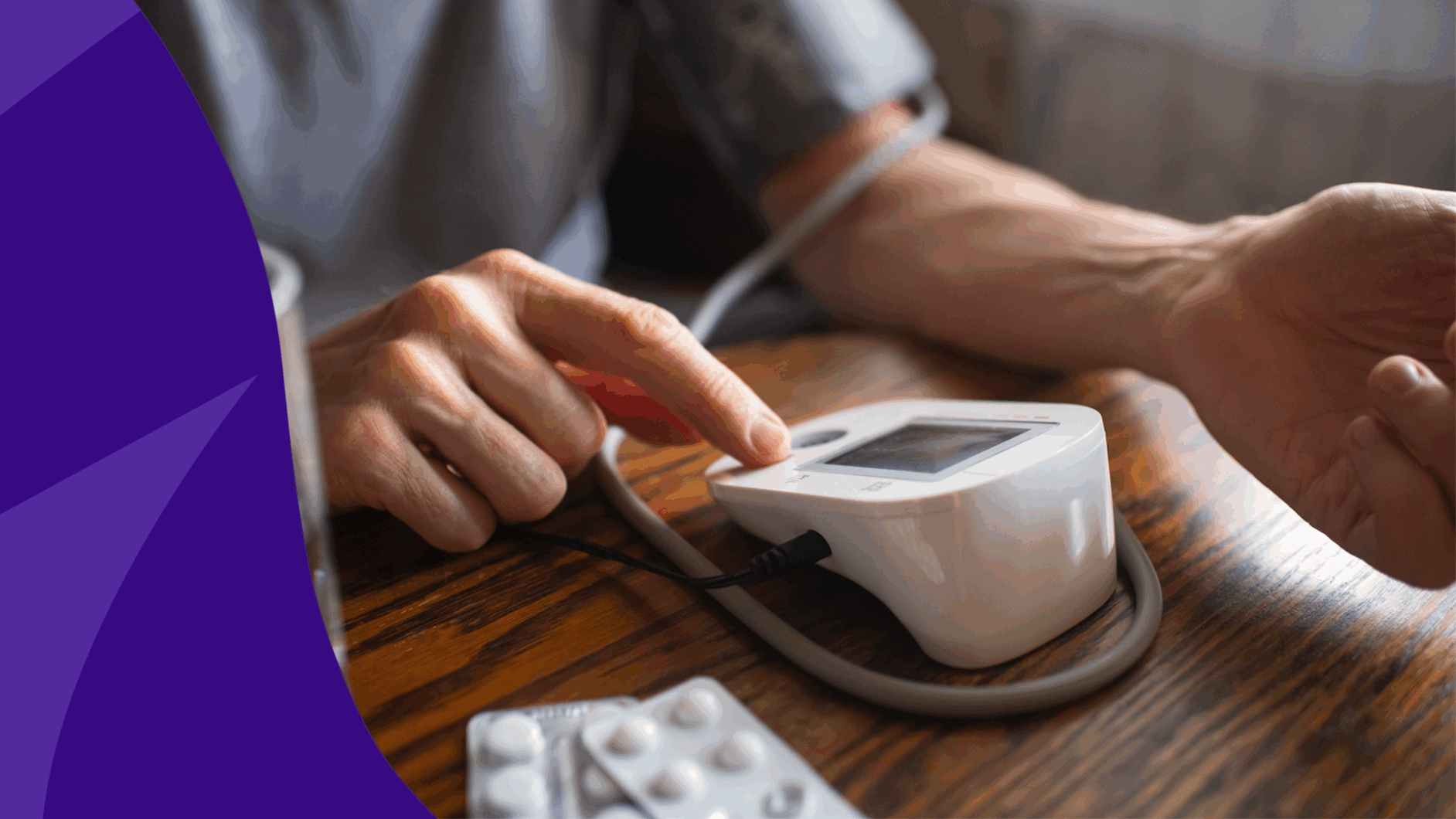 A person with a blood pressure cuff and pills | Does Jardiance lower blood pressure?