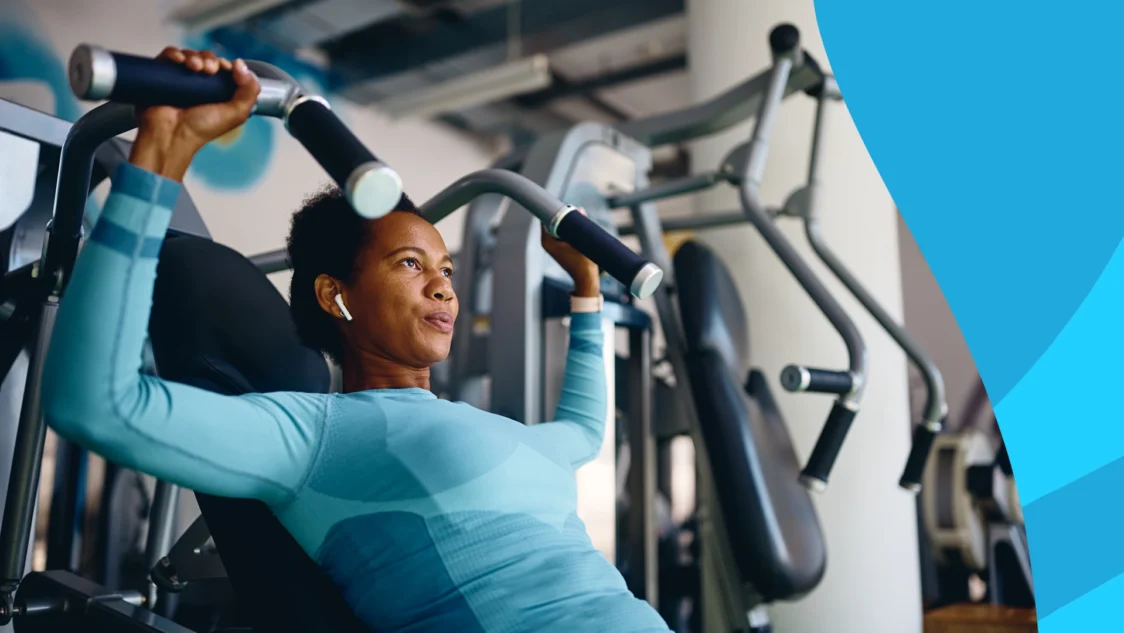 Image of a person lifting weights at the gym - Does exercise lower cholesterol?