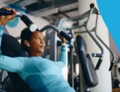 Image of a person lifting weights at the gym - Does exercise lower cholesterol?