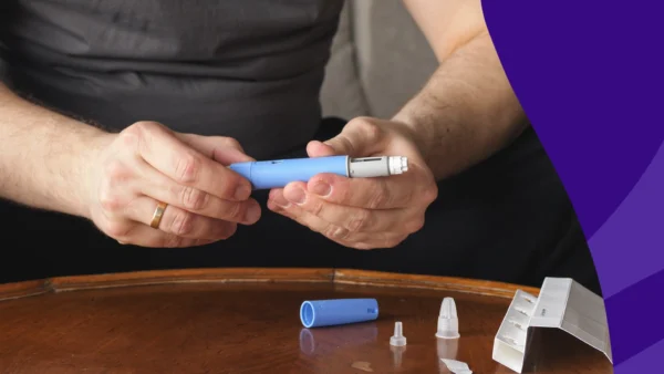 Hands holding a Mounjaro vial - when to increase Mounjaro dose for weight loss