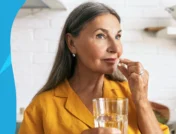 Image of a woman taking a vitamin e capsule - vitamin e benefits for women