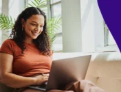 A woman reading SingleCare reviews on her laptop