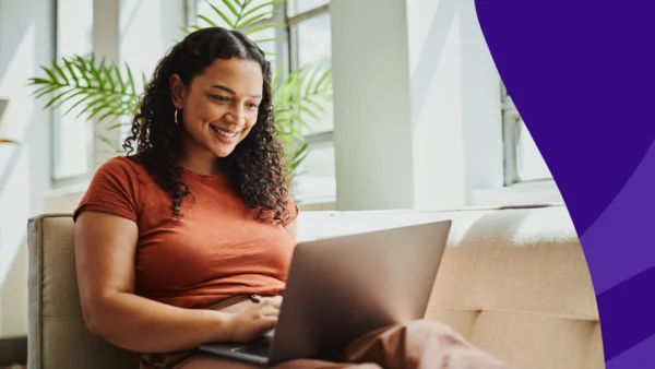 A woman reading SingleCare reviews on her laptop