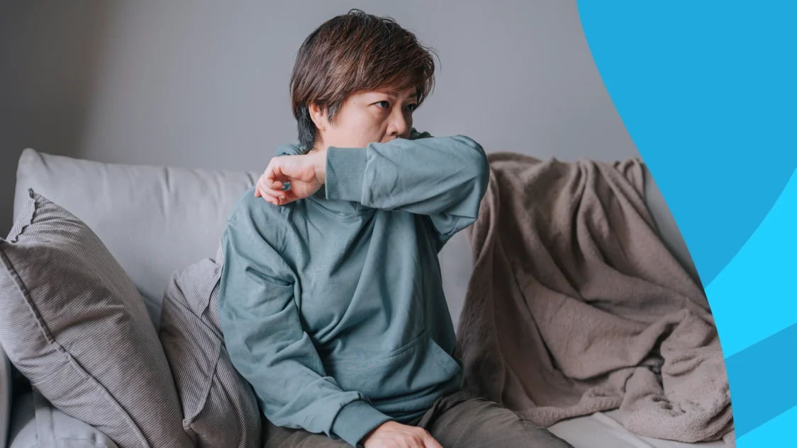 A woman covering a cough with her elbow | Does lisinopril cause a cough?