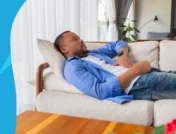 man laying down on the couch - Do statins make you tired?