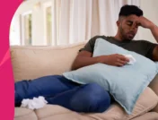 A man laying on the couch with tissues | Augmentin for sinus infection