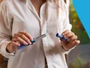 A woman with a GLP-1 pen | Does Mounjaro make you tired?