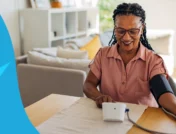 A woman using a blood pressure monitor | Does magnesium lower blood pressure?