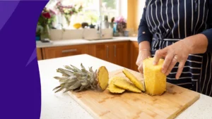 A person chopping pineapple | Pineapple benefits