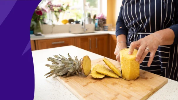 A person chopping pineapple | Pineapple benefits