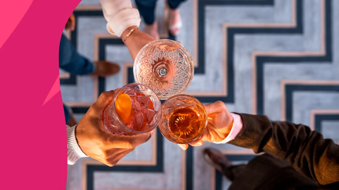 Image of people clinking cocktail glasses in a cheers - Bactrim and alcohol