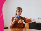 A woman looking at watch | How long does it take for omeprazole to work?