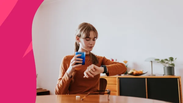 A woman looking at watch | How long does it take for omeprazole to work?