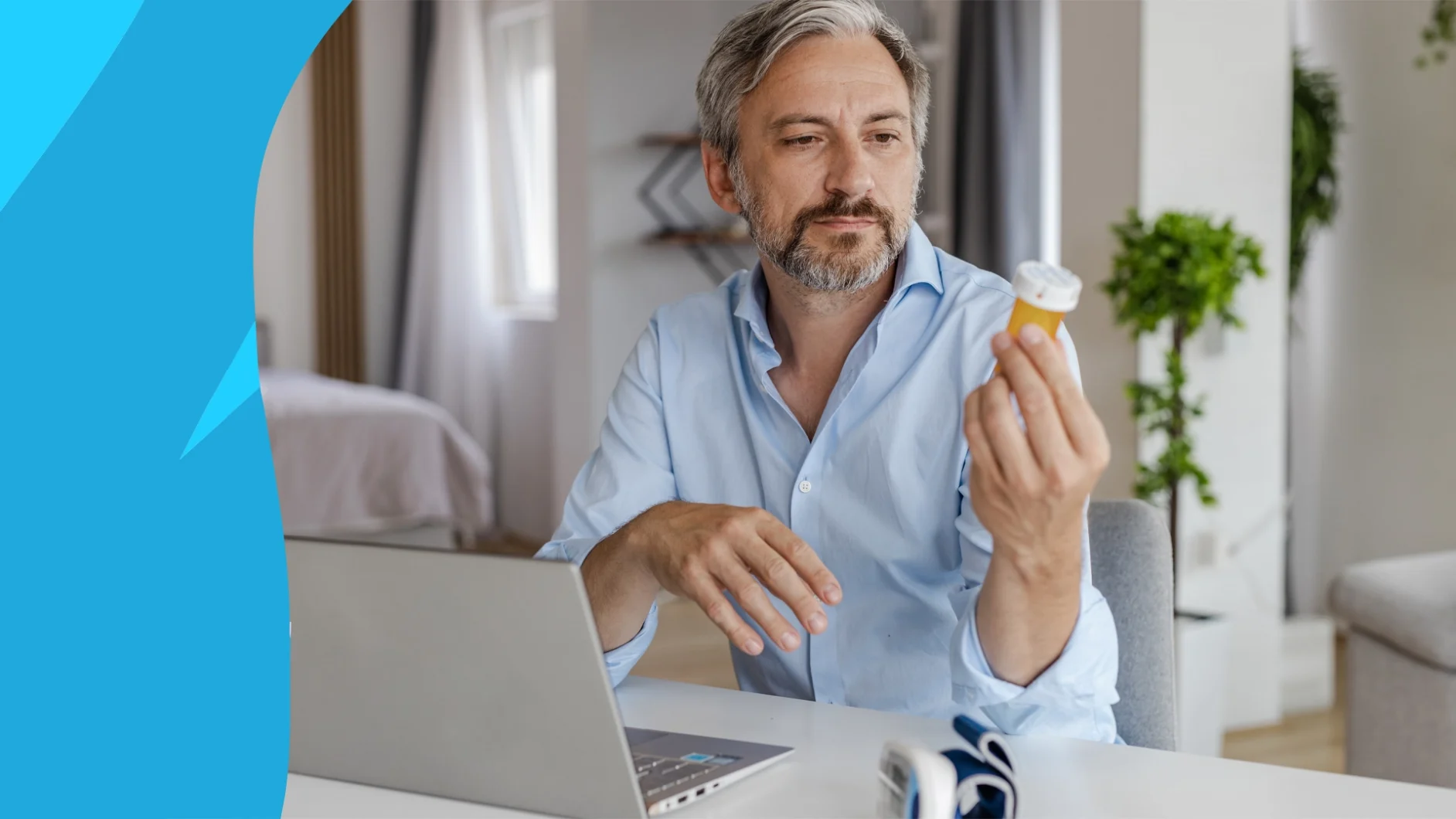 A man researching, "Does amlodipine cause erectile dysfunction?" on his laptop