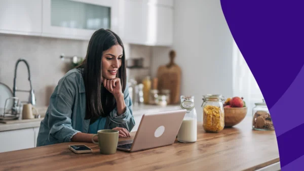 Woman using laptop in kitchen: How Americans use AI for medicine advice