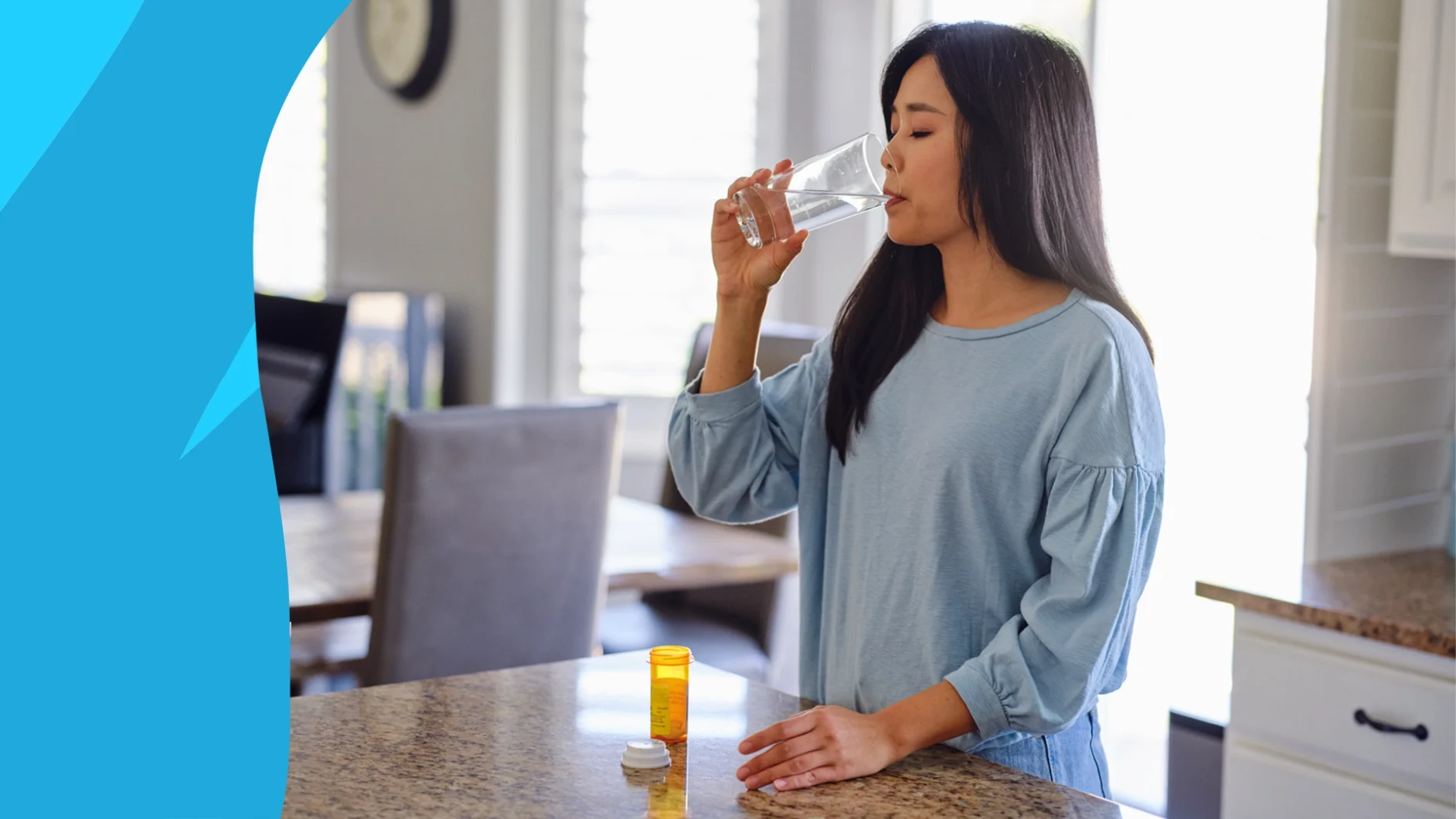 A woman taking clindamycin for UTI with a glass of water