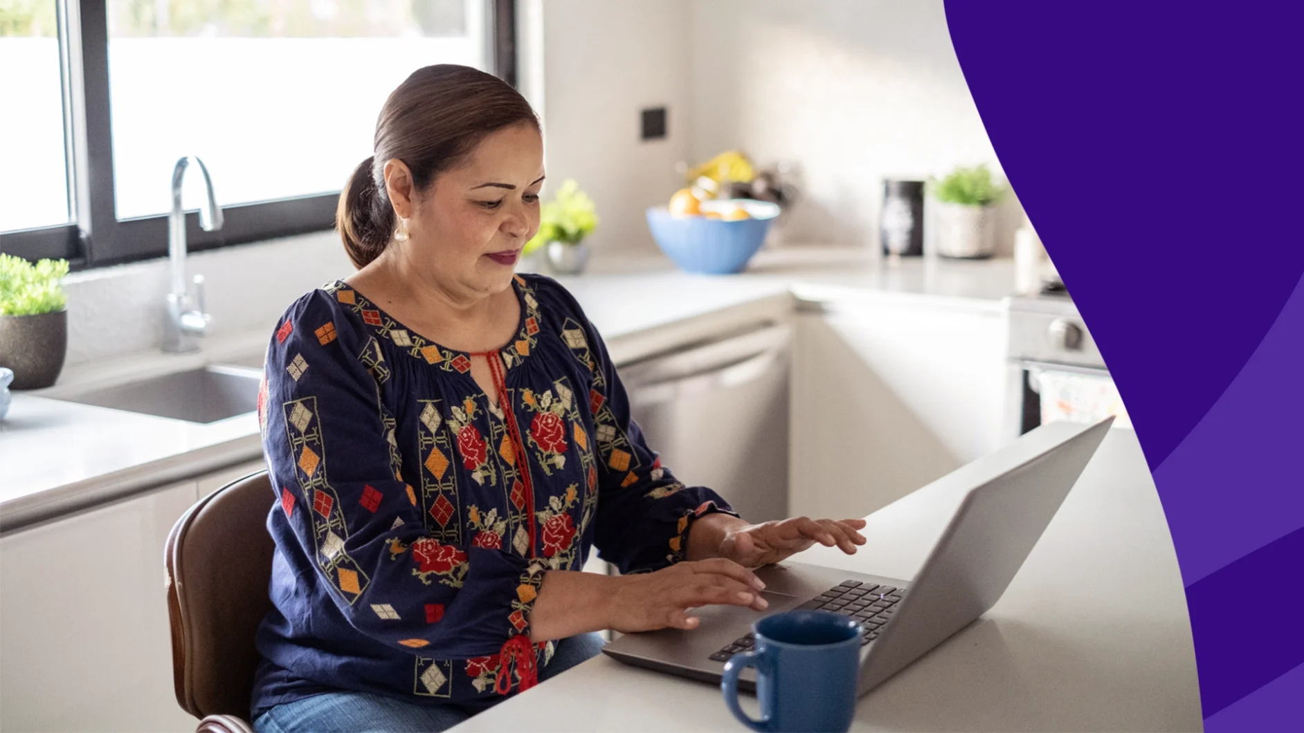 Woman sitting at a desk and using a laptop reading SingleCare's top May reviews