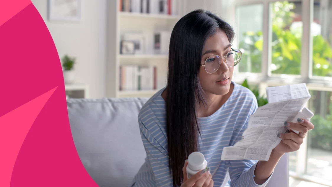 Woman holding a pill bottle and reading the prescribing information to represent how to take sucralfate for best results