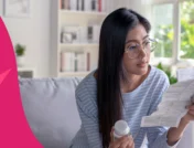 Woman holding a pill bottle and reading the prescribing information to represent how to take sucralfate for best results