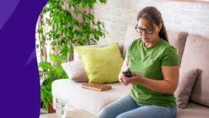 Woman sitting on the couch with a bottle of GLP-1 supplements - glp-1 supplements