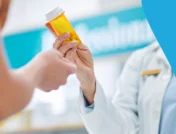 Image of a pharmacist handing a patient a prescription to represent Calypta cost without insurance