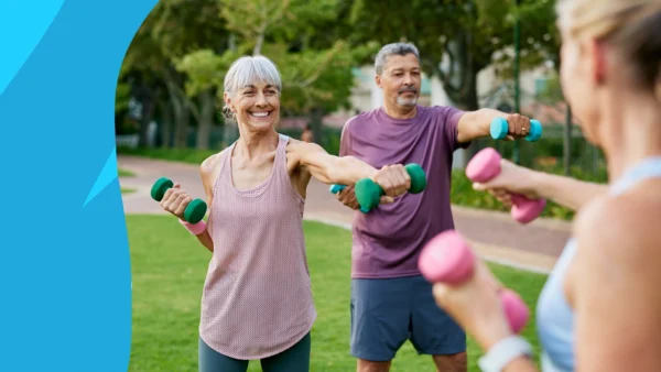 Image of older adults exercising in the park with hand weights to represent how to rebuild muscle over 60