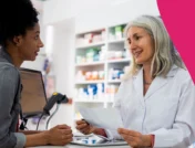 Image of a pharmacist speaking to a patient about discount cards