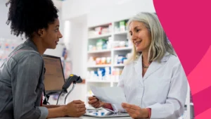 Image of a pharmacist speaking to a patient about discount cards
