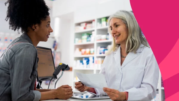 Image of a pharmacist speaking to a patient about discount cards