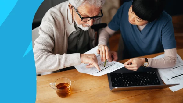 A professional explaining something on paper to a patient: Breztri prior authorization