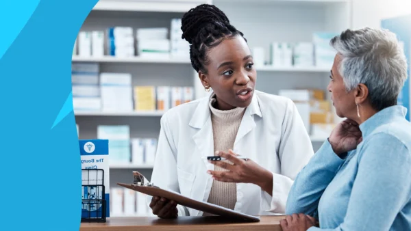 Pharmacist speaking to a patient to represent how pharmacists can help with Medicare Open Enrollment